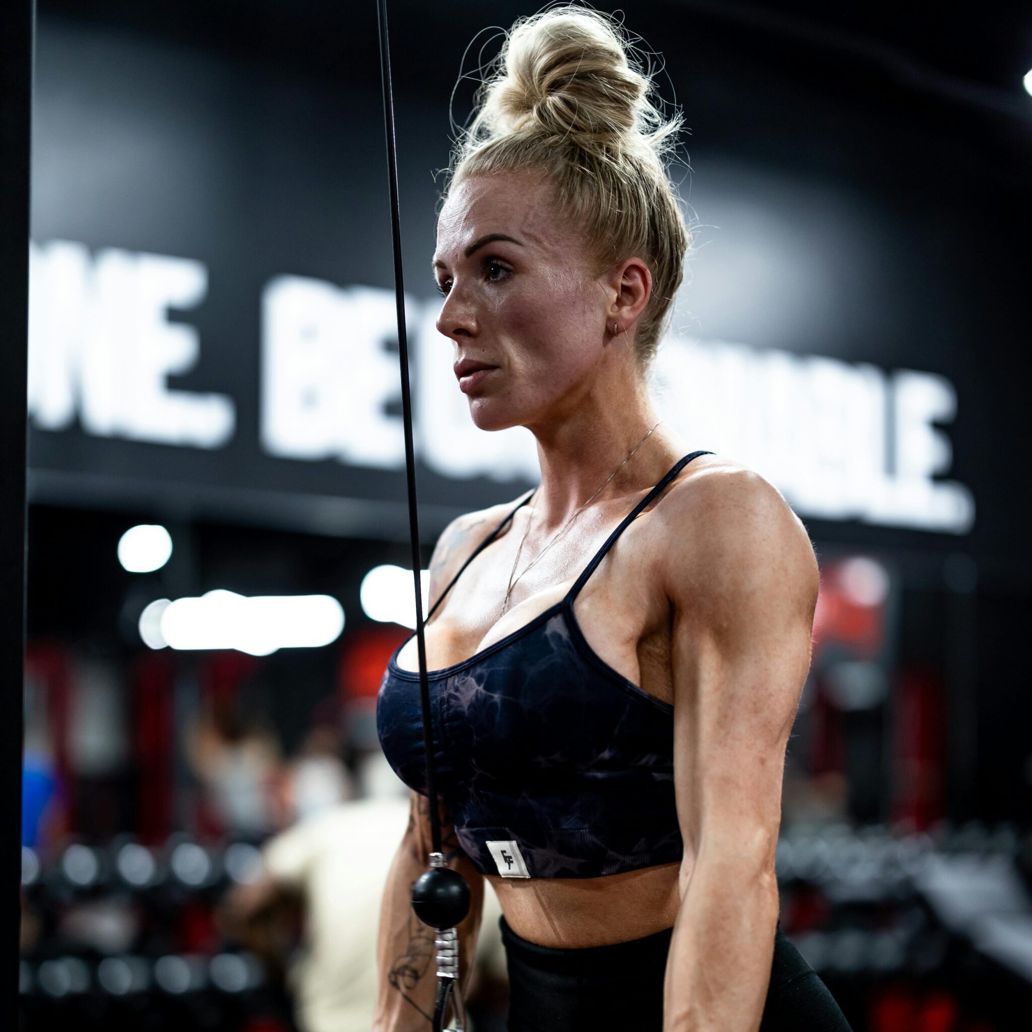 muscle works female athlete training in gym for strength and muscle definition